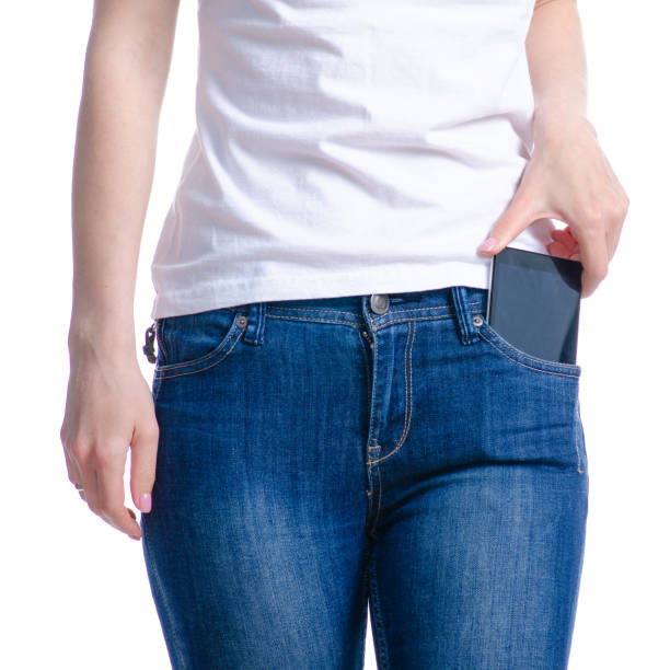 istock Woman puts mobile phone in jeans pocket 1148241236
