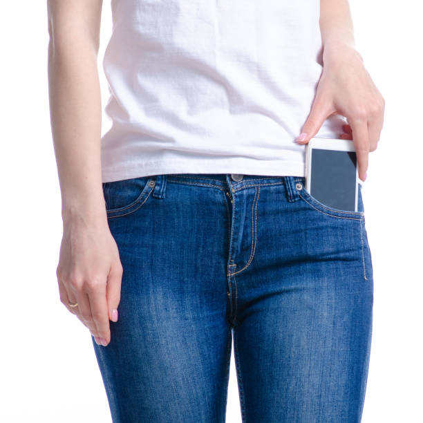 istock Woman puts mobile phone in jeans pocket 1148241239