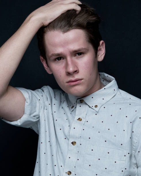 istock Young handsome man standing in front of black background 1148242602