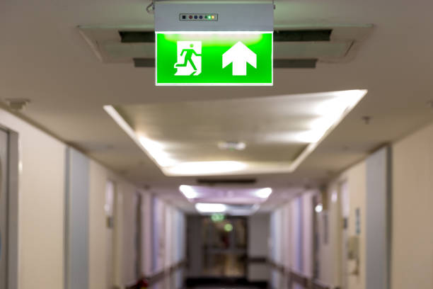 istock Green emergency exit sign showing the way to escape.Fire exit in the building. 1148243951