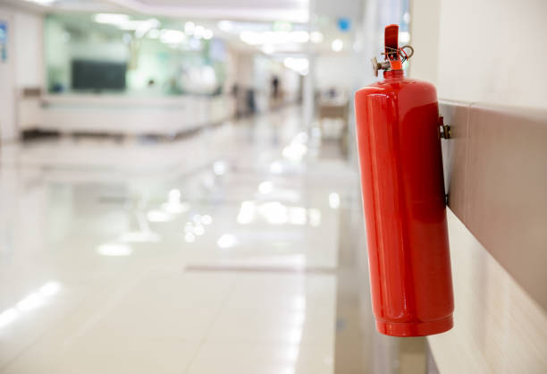 istock Fire extinguisher in the operating department . Install a fire extinguisher on the wall in building. Dry chemical powder fire extinguisher in corridor 1148245906