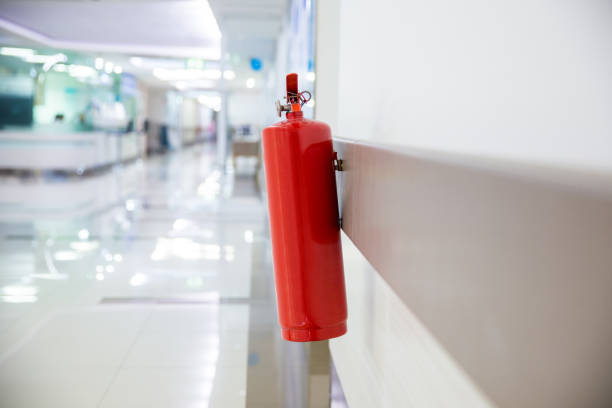 istock Fire extinguisher in the operating department . Install a fire extinguisher on the wall in building. Dry chemical powder fire extinguisher in corridor 1148245910
