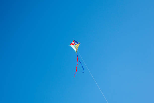 istock Colorful kite flying with waving red bow 1148245939