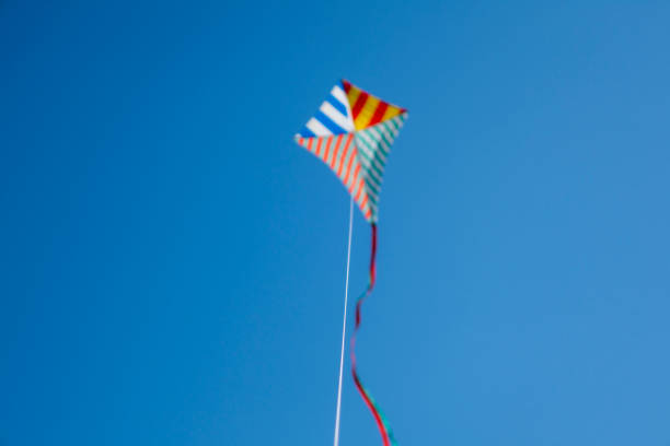 istock Colorful kite flying with waving red bow 1148245942