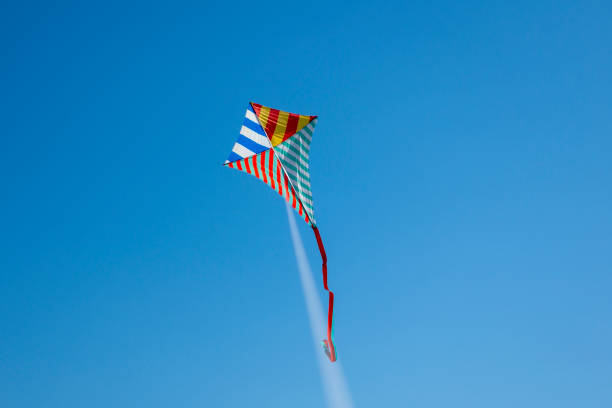 istock Colorful kite flying with waving red bow 1148245944