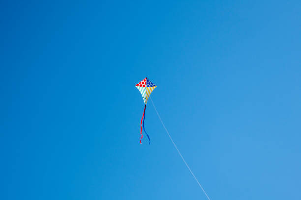 istock Colorful kite flying with waving red bow 1148245945