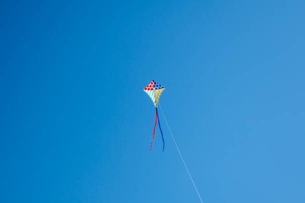 istock Colorful kite flying with waving red bow 1148245946