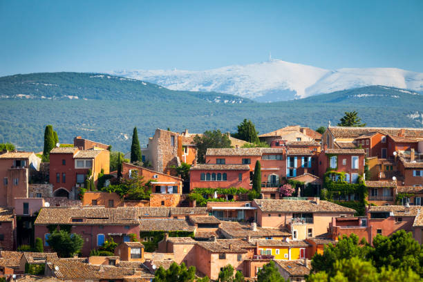Roussillon, France - July 20, 2013: Roussillon village with Mount Ventoux in background, Vaucluse region, Provence, France