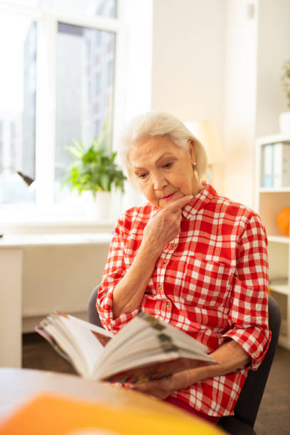 istock Serious nice aged woman touching her chin 1148246335