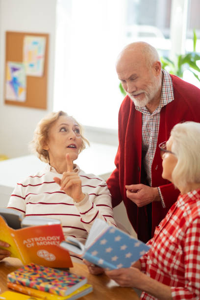 istock Delighted aged man standing near his friends 1148246352