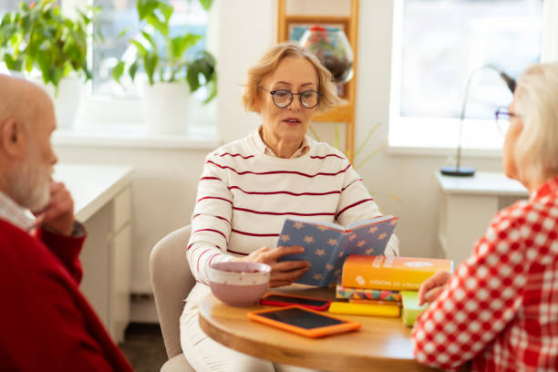 istock Good looking pleasant woman looking into the book 1148246373