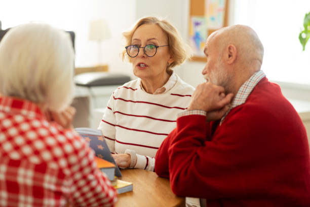 istock Pleasant aged woman reading quotes from the book 1148246396