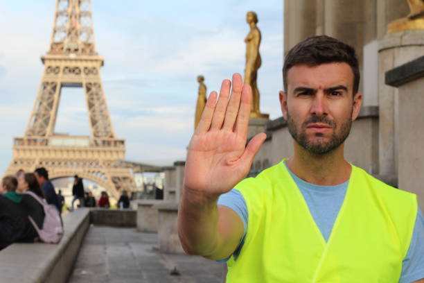 istock Man wearing yellow vest protesting in Paris, France 1148246407