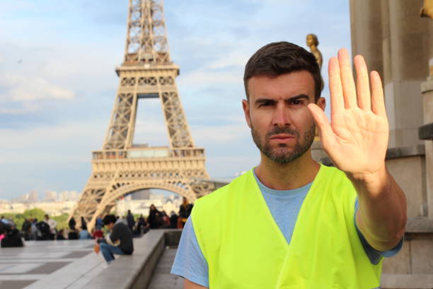 istock Man wearing yellow vest protesting in Paris, France 1148246455