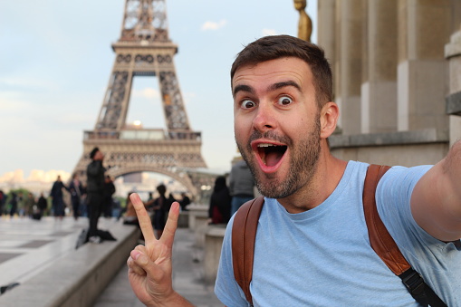 Ecstatic man taking a selfie in the Eiffel Tower, Paris.