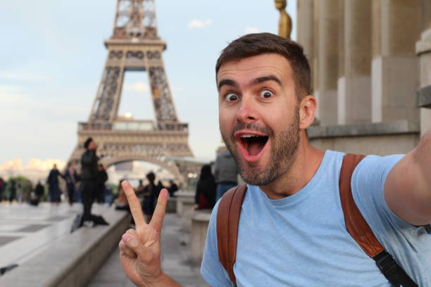 Ecstatic man taking a selfie in the Eiffel Tower, Paris stock photo