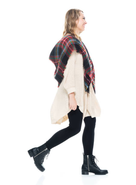 istock Beautiful female wearing scarf and sweater - hands by side walking 1148246576