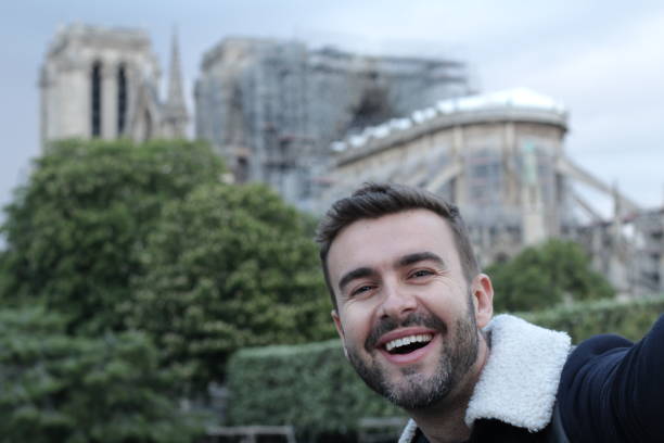 istock Man taking a selfie in burned Notre Dame, Paris 1148246601