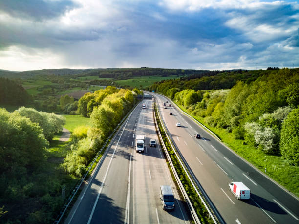 Highway in Germany Highway in Germany with cars and sky with big clouds autobahn stock pictures, royalty-free photos & images