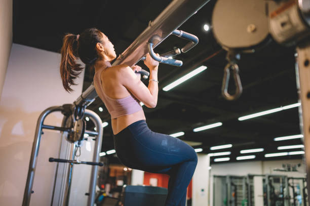 istock an asian chinese female working out with her bicep during routine exercise in gym 1148247283