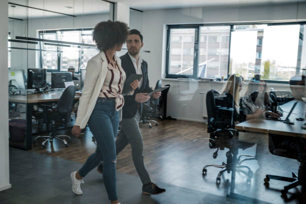 istock Business colleagues walking in the office 1148248923