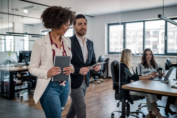 istock Business colleagues walking in the office 1148248924