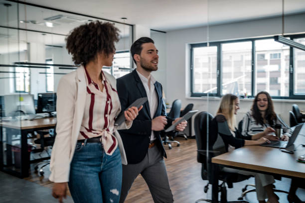 istock Business colleagues walking in the office 1148248931