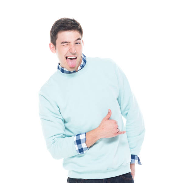 Attractive man is super happy Attractive man wearing sweater and jeans young man wink stock pictures, royalty-free photos & images