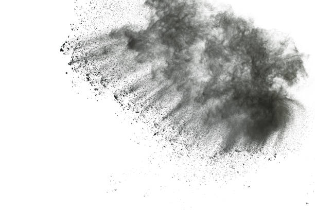 istock Black powder explosion. Closeup of black dust particles explode isolated on white background. 1148249136