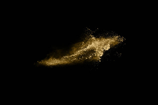 istock Golden powder explosion on black background. Freeze motion. 1148249169