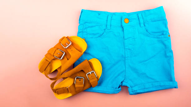 istock Sandals and shortson a pink background. 1148252014