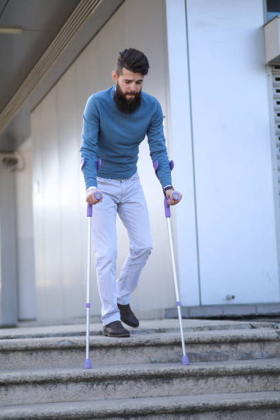 istock Blind and bearded man with a walking stick on the street 1148252699