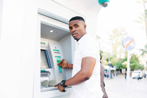 istock Portrait of African man using ATM 1148253902