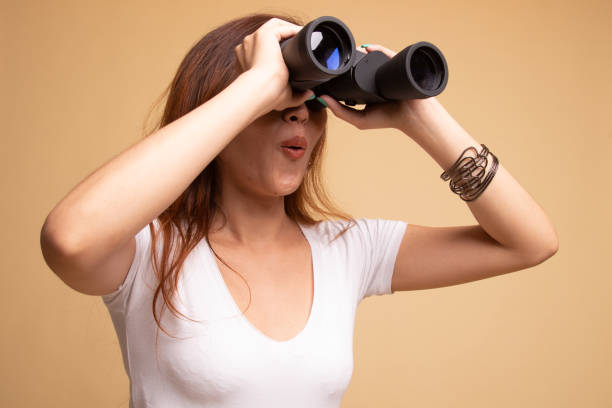 istock Young Asian woman with binoculars. 1148254572