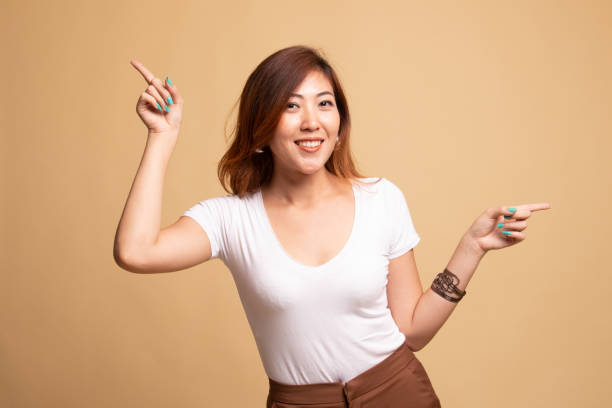 istock Young Asian woman point with two hands. 1148255218