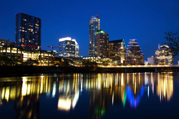 austin skyline reflected in the river, austin, texas - travis county stock-fotos und bilder