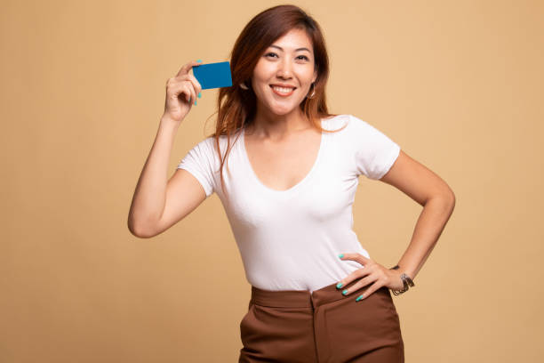 istock Young Asian woman smile with blank card. 1148257244