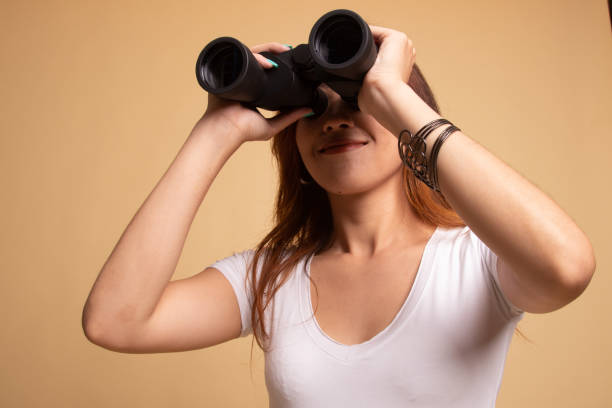 istock Young Asian woman with binoculars. 1148257259