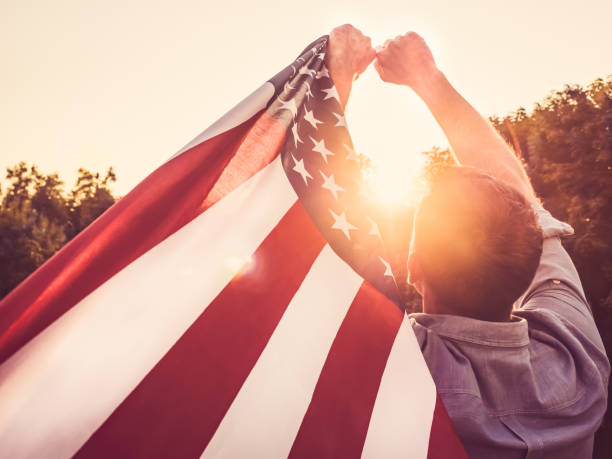 istock Handsome, young man waving an American flag 1148257329