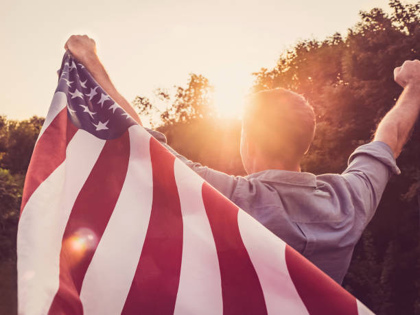 istock Handsome, young man waving an American flag 1148257391