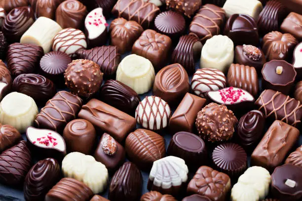 Assortment of fine chocolate candies, white, dark, and milk chocolate. Sweets background