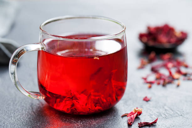 istock Hibiscus tea in glass cup. Grey background. Close up. 1148258061