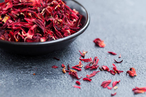 istock Hibiscus tea in black bowl. Slate background. Close up. Copy space. 1148260213