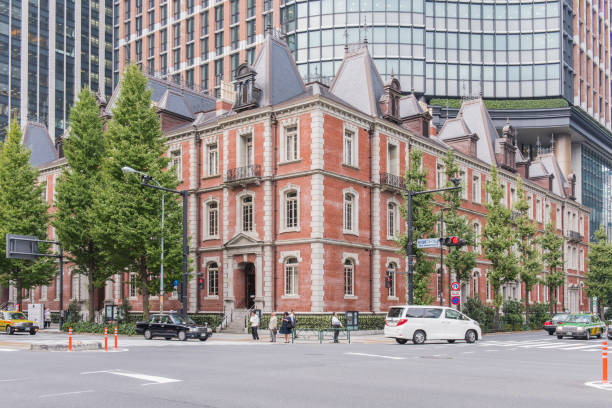 view of people walking in the street near to the tokyo station in the chiyoda ward, tokyo city, japan. - tokyo station railroad station chiyoda ward building exterior imagens e fotografias de stock