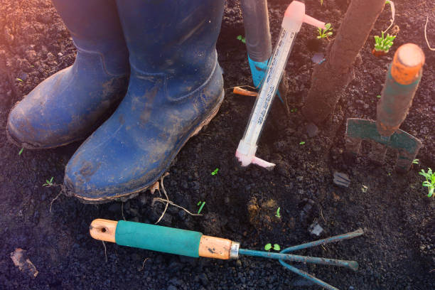 istock armer rubber boots and equipment in a garden. 1148260362
