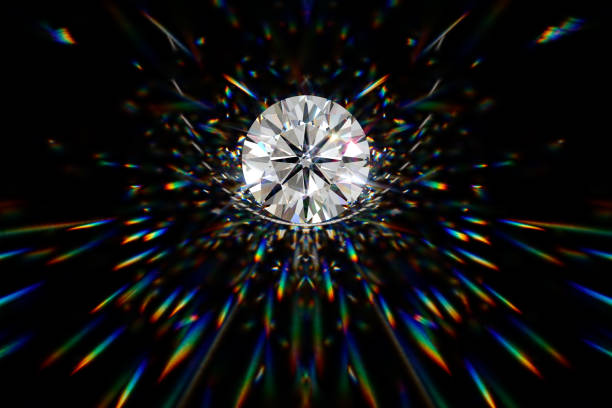istock Round cut diamond on black background with beautiful colorful caustics rays 1148262070