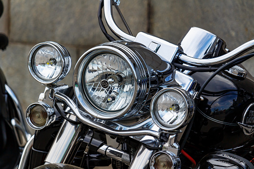 Moscow, Russia - May 04, 2019: Chrome headlights with direction indicators of Harley Davidson motorcycle closeup. Moto festival MosMotoFest 2019