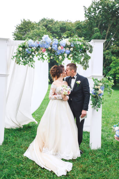 istock Young beautiful couple kissing at wedding reception 1148264430