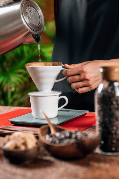 istock Drip Coffee Making. Barista Pouring Boiling Water From Kettle in Manual Drip Coffee Pot 1148264437
