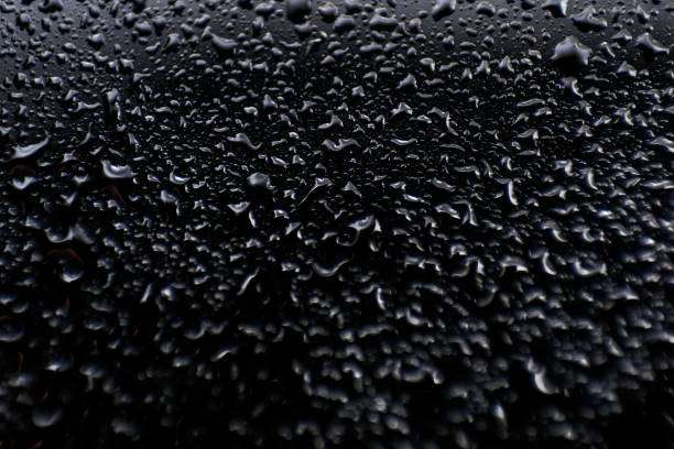 istock oil and water drops on black glass surface abstract background 1148265419